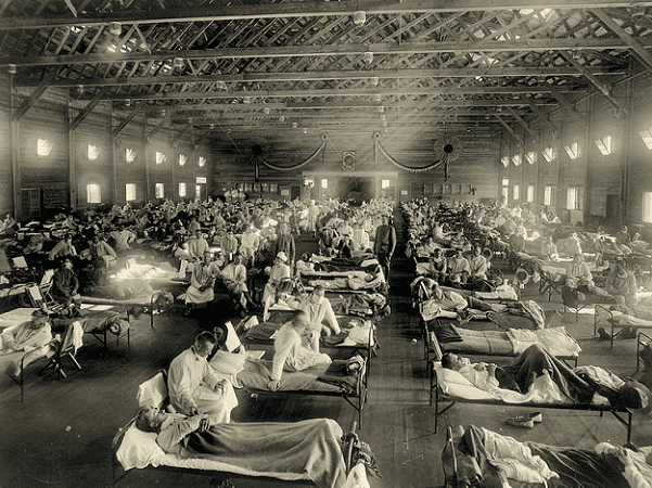 Photo: soldiers from Fort Riley, Kansas, ill with Spanish flu at a hospital ward at Camp Funston, Kansas. Credit: Otis Historical Archives, National Museum of Health and Medicine; Wikimedia Commons.