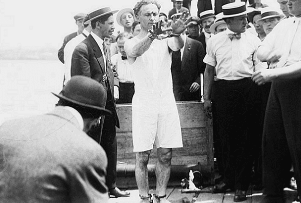 Photo: Harry Houdini prepares to do the Overboard box escape, c.1912. Credit: Bain News Service; U.S. Library of Congress, Prints and Photographs Division.