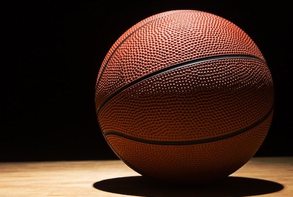 basketball on the hardwood in a spotlight
