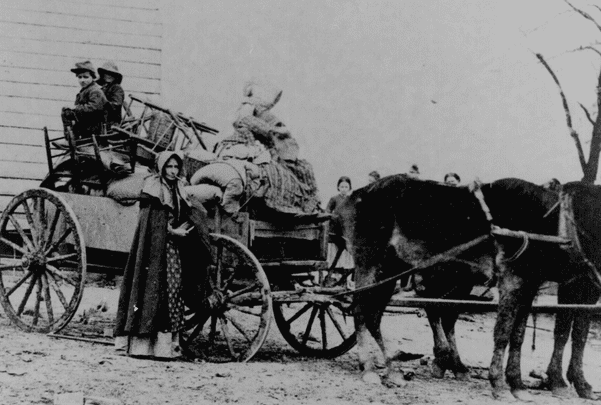 Photo: a refugee family during the Civil War leaving a war area with belongings loaded on a cart. Credit: National Archives.