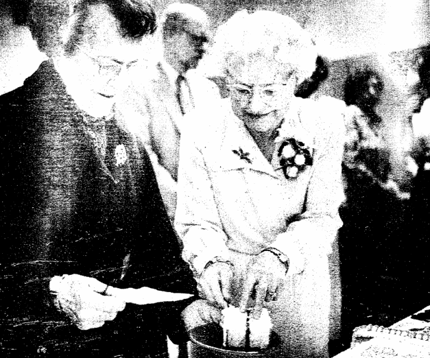 Photo: Clara Breed serving cake at a reception honoring her for being named librarian emeritus by the San Diego City Council. Receiving a slice is Grace Klauber. 