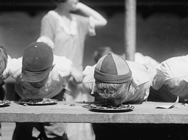 Photo: pie-eating contest at the Jefferson School, Washington, D.C., 2 August 1923. Credit: Library of Congress, Prints and Photographs Division.