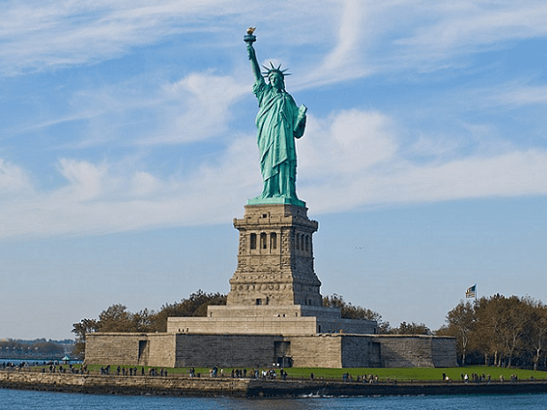 Photo: the Statue of Liberty (more formally, Liberty Enlightening the World, and more colloquially, Lady Liberty) located on Liberty Island in New York Harbor. Credit: William Warby; Wikimedia Commons.