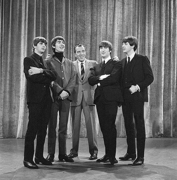 Photo: the Beatles with Ed Sullivan from their first appearance on Sullivan’s variety television program in February 1964