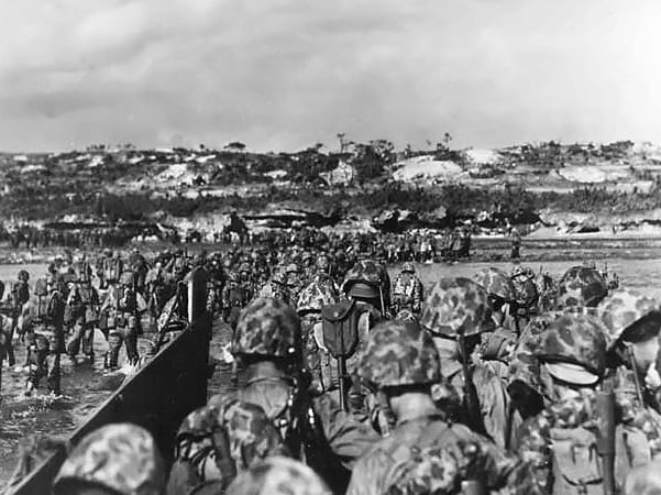 Photo: U.S. Marine reinforcements wade ashore to support the beachhead on Okinawa, 1 April 1945. Credit: National Archives; Wikimedia Commons.