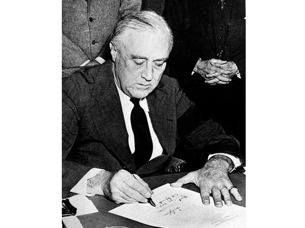 Photo: President Franklin D. Roosevelt signing the declaration of war against Japan, in the wake of the attack on Pearl Harbor, 8 December 1941. Credit: National Archives and Records Administration; Wikimedia Commons.