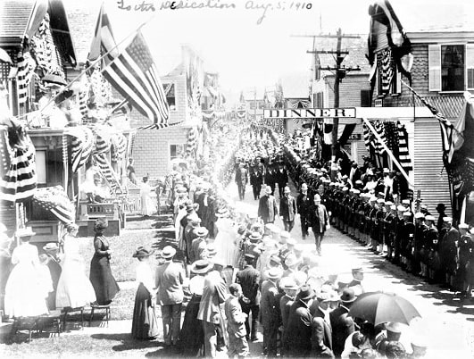 Photo: the presidential parade for the Pilgrim Monument dedication on 5 August 1910. The image shows the parade moving west down Commercial Street near the corner of Ryder Street. Credit: the Scrapbook Collection of John Dowd-Althea Boxell; Digital Commonwealth, Provincetown History Preservation Project.
