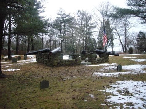 Photo: the four-cannon memorial erected above Captain Myles Standish’s grave in the Myles Standish Burial Ground in Duxbury, Massachusetts