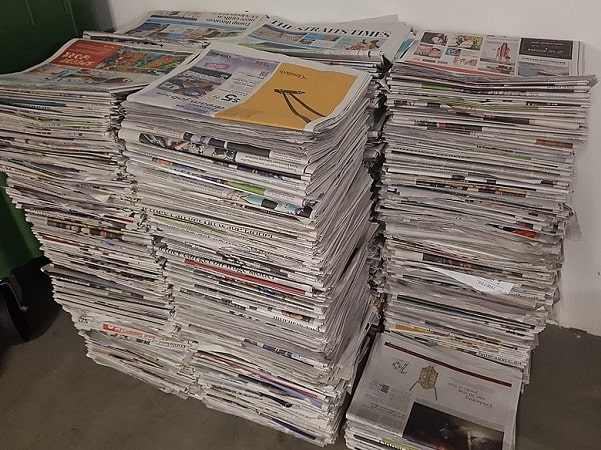 Photo: a stack of newspapers. Credit: Mokkie; Wikimedia Commons.