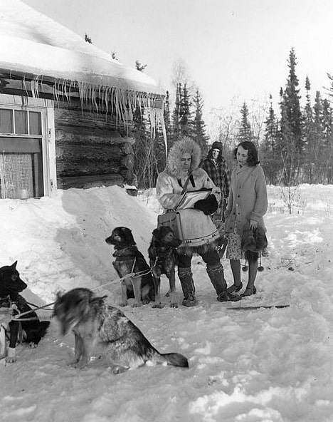 Photo: this 1940 Census publicity photo shows a census worker (left) collecting information from a respondent (right) in Fairbanks, Alaska. The dog musher (center, background) remains out of earshot to maintain confidentiality. 