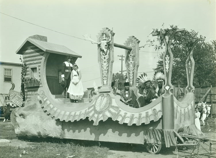 Photo: “John Alden and Priscilla at the Spinning Wheel” float from the 1920 “Pilgrims Pageant” parade in Omaha, Nebraska, sponsored by the Concord Club of Omaha. From the Louis R. Bostwick Collection, Folder RG 3147. Courtesy of the Nebraska Historical Society.