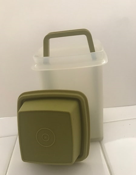 Photo: Tupperware “Pickle-Keeper” with the lid off, showing the handle that can be lifted to choose a pickle; holes in the bottom of the handle’s base allow the juices to stay in the container while the handle is lifted and the pickle extracted