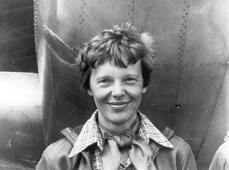 Photo: Amelia Earhart standing under nose of her Lockheed Model 10-E Electra – the plane she was flying when she mysteriously disappeared