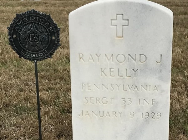 Photo: military headstone with an "American Legion" metal marker at the Kerrville National Cemetery in Kerrville, Texas. Credit: Gena Philibert-Ortega.