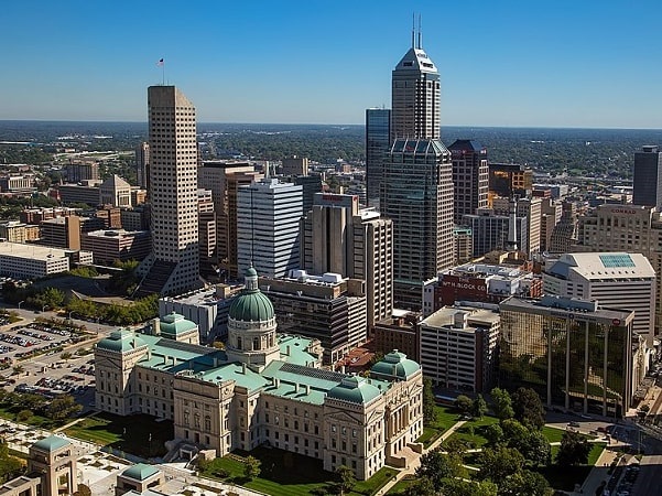 Photo: an aerial view looking east northeast across downtown Indianapolis. The Indiana Statehouse is visible in the foreground. Credit: tpsdave; Wikimedia Commons.