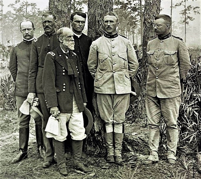 Photo: staff of the 1st U.S. Volunteer Regiment, the “Rough Riders,” in Tampa, Florida, 1898. Lt. Col. Theodore Roosevelt is on the right, General Leonard Wood is next to him and bearded former Civil War Confederate General Joseph Wheeler is standing in front. Taylor MacDonald is on the far left with Major Alexander Oswald Brodie and Champlain Brown. Credit: Library of Congress, Prints and Photographs Division.
