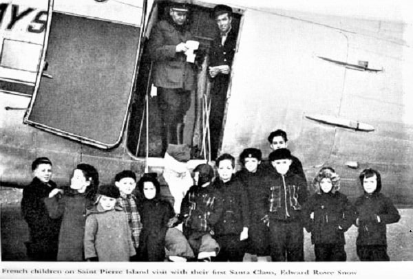 Photo: Edward Snow visits French children on Saint Pierre Island. Courtesy of The Friends of Flying Santa.