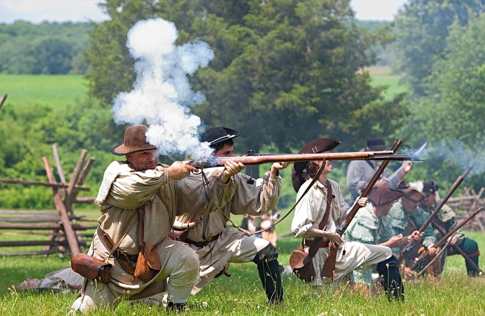 Photo: Revolutionary War reenactors shooting.