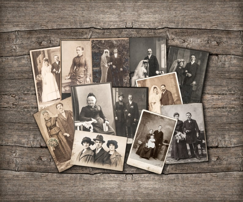 Photo: vintage family photos on a wooden background.