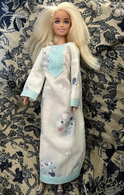 Photo: Barbie in tunic dress made by the author’s mother and grandmother. Credit: Gena Philibert-Ortega.