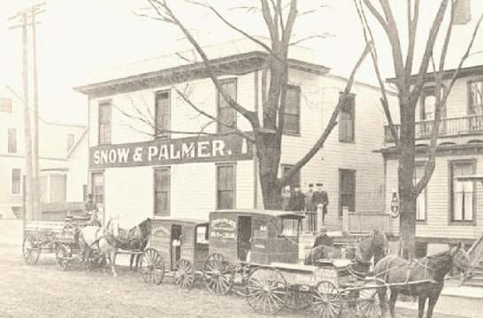 Photo: “Snow & Palmer,” from the 1907 coffee table book Picturesque Bloomington, shows several Snow & Palmer milk wagons in front of 602 W. Jefferson Street, Bloomington, Illinois. Courtesy of the McLean County Museum of History.