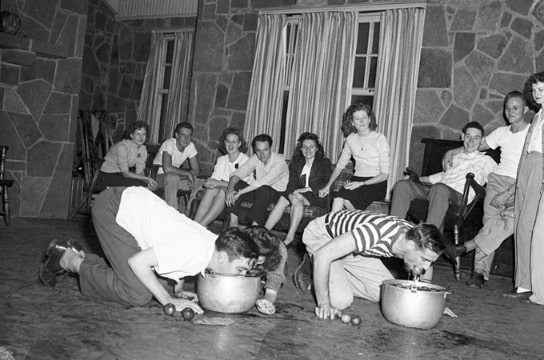 Photo: North Texas Agricultural College party with students bobbing for apples, c. 1930s. Credit: University of Texas at Arlington Photograph Collection; Wikimedia Commons.