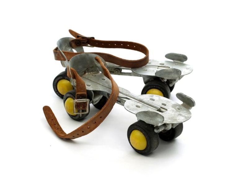 Photo: a pair of roller skates within the permanent collection of The Children’s Museum of Indianapolis. Skates like these fit over shoes and were adjustable. Credit: The Children’s Museum of Indianapolis; Wikimedia Commons.