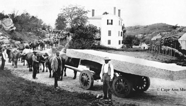 Photo: ox team hauling granite slab on Washington Street, annisquam, Massachusetts. Colonel Jonas French is standing second to the right. According to sources, Elizabeth Blood, widow of Joseph Blood, sold the quarry and lands to Col. French for the sum of $2,500. Credit: Annisquam Historical Society.