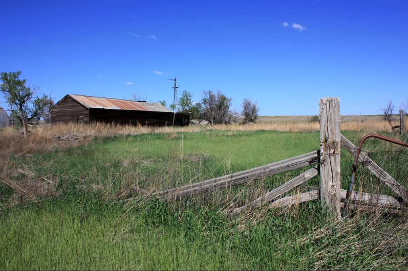 Photo: an old barn and field.