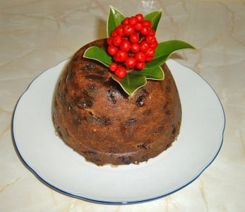 Photo: Christmas Plum Pudding, decorated with skimmia rather than holly. Credit: Musical Linguist; Wikimedia Commons.