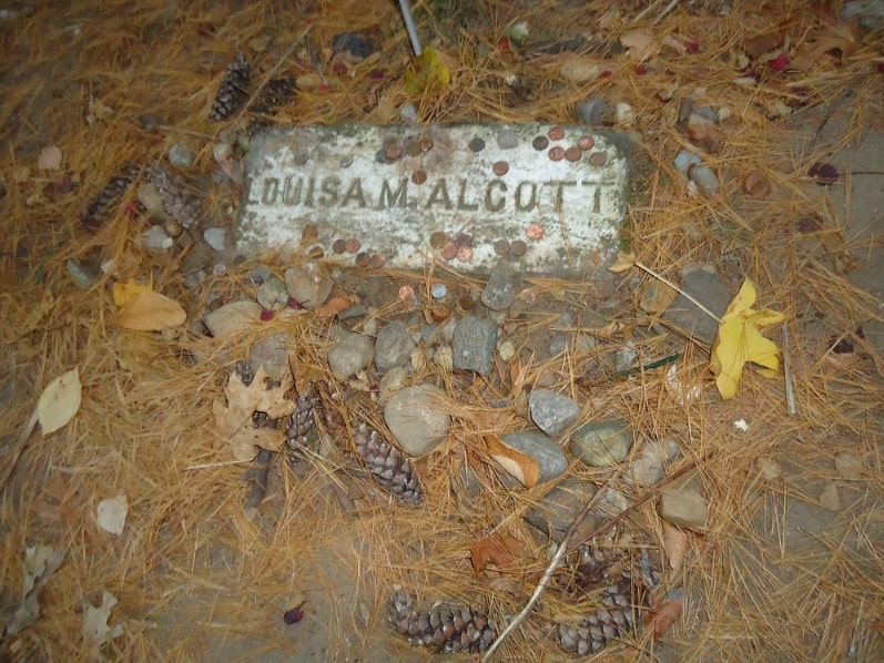 Photo: Louisa May Alcott’s grave in Sleepy Hollow Cemetery, Concord, Massachusetts. Credit: Tomwsulcer; Wikimedia Commons.