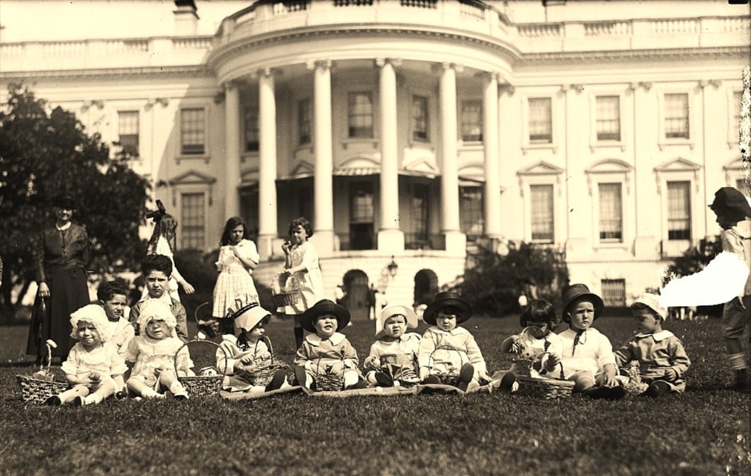 Photo: children in Easter outfits with baskets ready to hunt for Easter eggs on the South Lawn of the White House. Photographers: Harris & Ewing, 1920s. Credit: Library of Congress, Prints and Photographs Division.