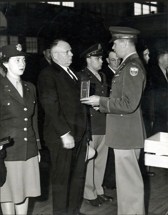 Photo: Linwood “Sarge” Blair receives his son’s Air Medal at Hamilton Field, California, on 30 January 1944. Credit: Brisbane Library History Collection.