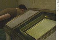 Photo: a visitor to the National Archives examines the Bill of Rights